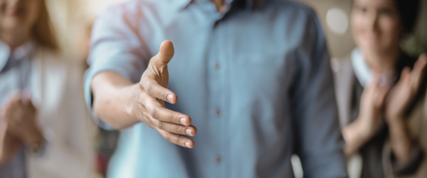 Hand extended out towards camera as to welcome someone